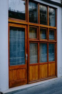Elegant wooden storefront featuring large glass panels and minimalistic design.