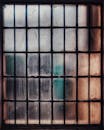 A weathered and dirty glass window with a rusty frame, featuring textured panes and a vintage look.